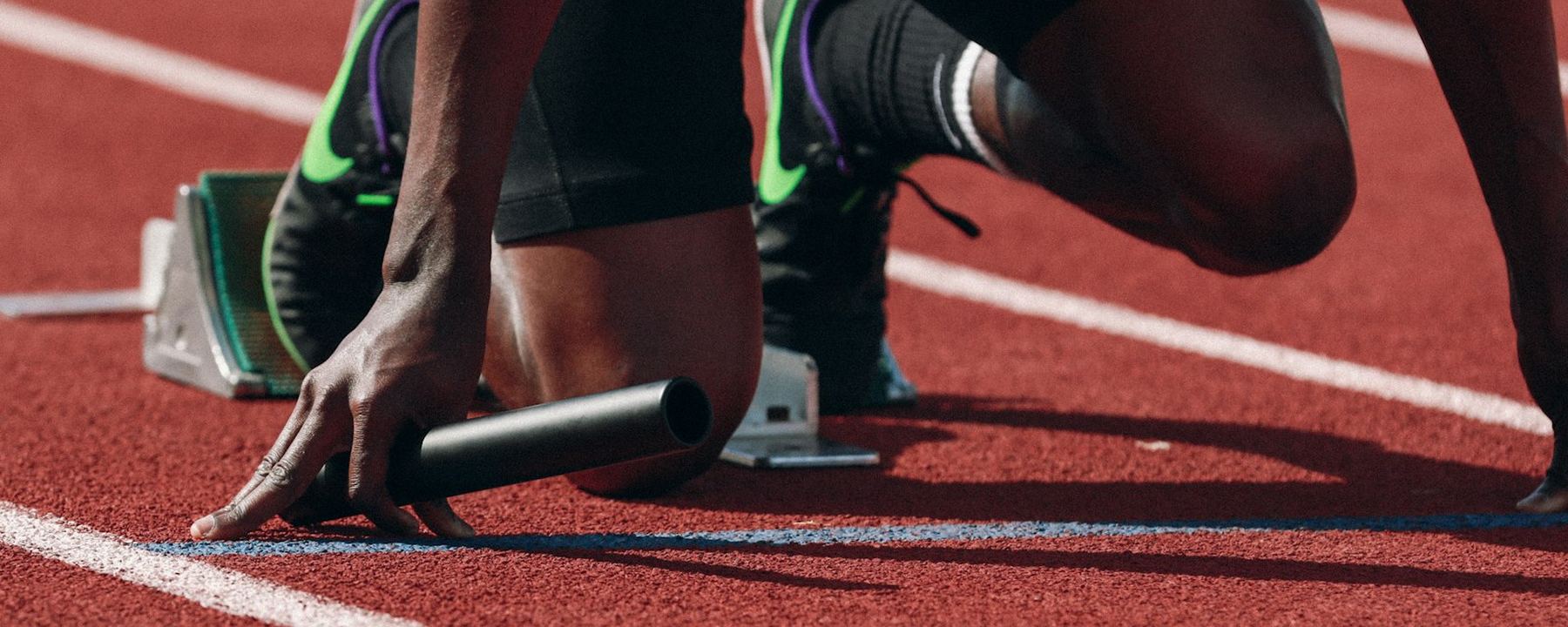 A sprinter set in the starting blocks on a track