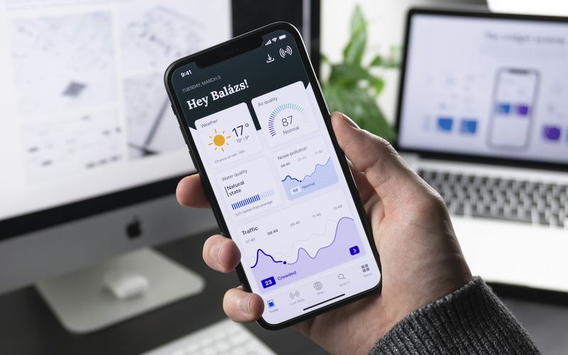 Hand holding a phone running a modern app